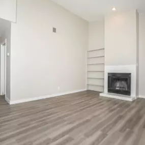 interior living room hardwood floors fireplace and shelves
