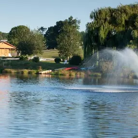 A body of water, fountain and canoes at Christmas Mountain Campground