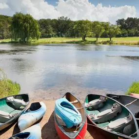 8 canoes by the shoreline of a lake at Christmas Mountain Campground