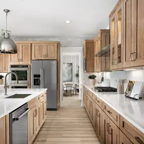 Gourmet kitchens with large center islands and premium countertops, cabinetry, and flooring