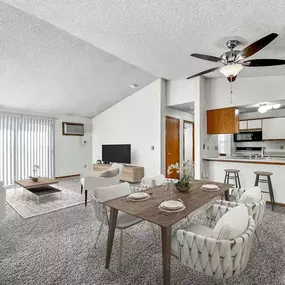 A living room with a dining table and chairs