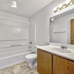 a bathroom with a sink toilet and a bath tub