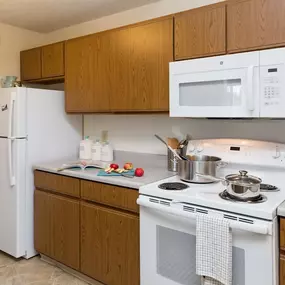 a kitchen with a stove microwave and refrigerator at Somerset Apartments, Des Moines, IA