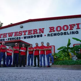 Roofing staff in Houston showing camaraderie and unity in front of our building and sign.