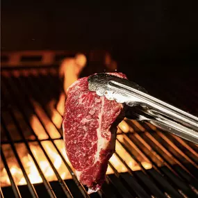 Stoke steak on grill