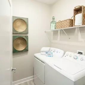 Laundry room with full-size washer and dryer at Camden Clearwater apartments in Clearwater, FL