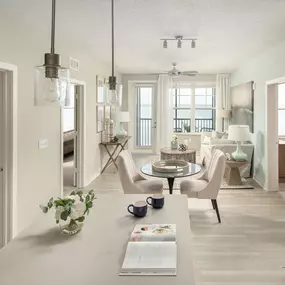 Kitchen with island and pendant lighting leading to dining and living room at Camden Clearwater apartments in Clearwater, FL