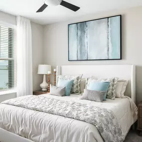 Primary bedroom with ceiling fan and view of the bay at Camden Clearwater apartments in Clearwater, FL
