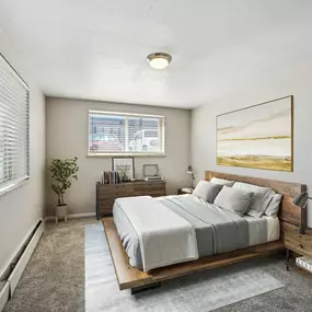 A bedroom with a bed and a window