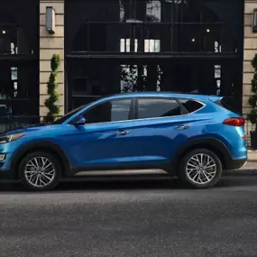Side profile of a Hyundai SUV parked on a city street