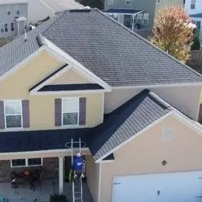 An aerial view of a two-story house with a newly installed dark gray shingle roof. The house is located at 631 Dunrobin Ln, Grovetown, GA 30813.