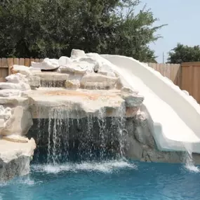 Pool grotto in stone, waterfall and slide