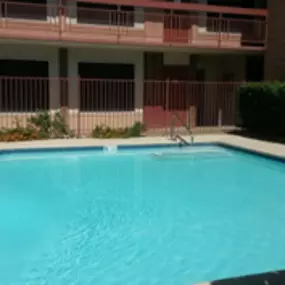 A small pool in front of a building.