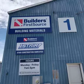 Exterior view of a Builders FirstSource facility with signage indicating 