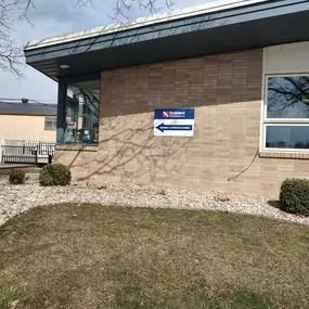 Exterior view of a Builders FirstSource office building with a sign indicating 