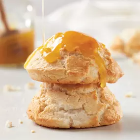 Golden, flaky biscuits topped with sweet sauce—freshly baked and perfect as a side or a snack. Southern comfort in every bite.