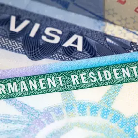 Close-up image of U.S. permanent resident and visa documents, symbolizing Ibrahim & Dobaria Law, PLLC’s dedicated immigration services, helping clients secure legal status, green cards, and visas efficiently and professionally.