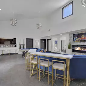 Clubhouse with ample seating, electric fireplace, flat screen tv, and pool table.