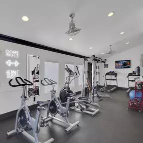Fitness center with cardio machines and free weights.