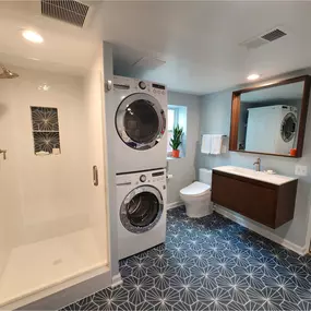 Adding a Basement Bathroom and Laundry - 1950s house in Falls Church City. Client only had 1 full bathroom and a full house! They wanted to take the unfinished laundry room and turn it into a new basement bathroom plus laundry. First our design team laid out the space and then helped the client pick all the finishes. There was a lot of planning due to the limited space and the need to meet code spacing in front of the shower, sink and toilet. The toilet would only have 1