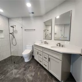Arlington Primary Bathroom - Another great example of a bathroom that is updated but things stay generally in the same place. This bathroom received a new curbless shower with a wide wall niche. Dual sink vanity with recessed medicine cabinet mirrors. A standalone tub with floor mounted faucet. The existing half moon window was rotting away so we replaced it with a new window that has a fiberglass frame.