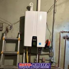A newly installed tankless water heater is mounted on a wall, showcasing Roto-Rooter’s plumbing expertise in efficient water heating system upgrades.