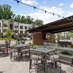 A sunny day at a modern outdoor seating area with tables and chairs.
