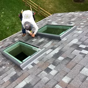Putting the finishing touches on the skylights of this full roof replacement.