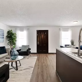 A living room with a couch and a sink