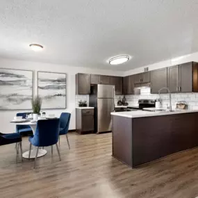 A kitchen and dining room with a table and chairs