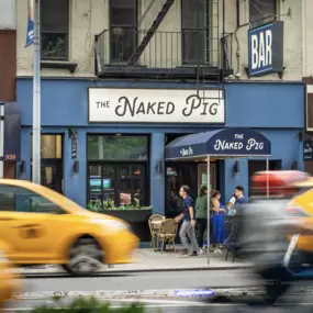 taxis passing the naked pig