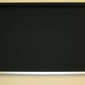 Solid black roller shade with a sleek silver bottom bar