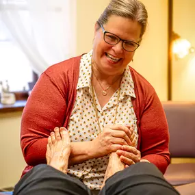 Kimberly performing a relaxing foot reflexology session.