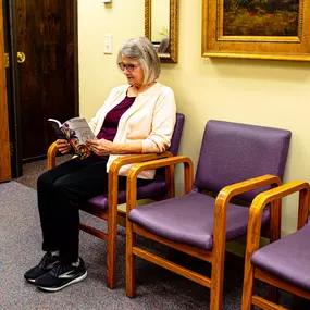 A woman waiting comfortably in the reception area of Wonderfully Made.