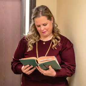 Kimberly reflecting in prayer and scripture before a client session.