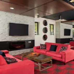 Cozy resident clubhouse with a fireplace and a television