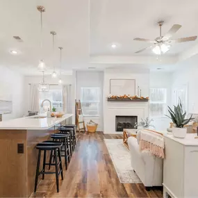 A modern farmhouse blends rustic charm with contemporary style, featuring clean lines, gabled roofs, and a mix of wood, metal, and neutral tones. Open floor plans, large windows, and cozy, functional spaces create a warm yet stylish aesthetic.