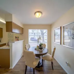 A kitchen and dining room with a table and chairs