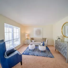 A living room with a couch and a chair and a table