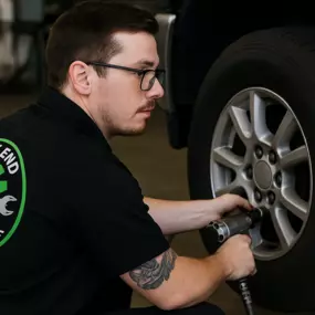 Percy at East End Automotive in Oak Ridge working on removing a tire to perform a standard tire rotation.