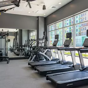 A gym with treadmills, weights, and exercise equipment
