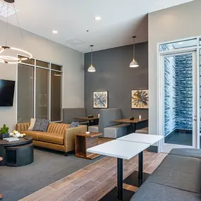 A modern living room with a flat screen TV mounted on the wall