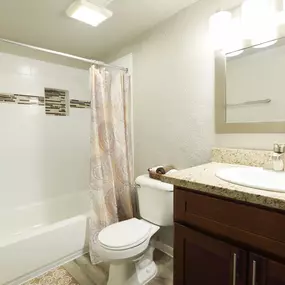 Bathroom with bathtub and large mirror
