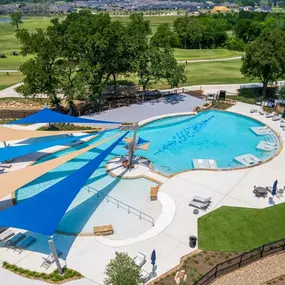 Resort-style pool with in-pool loungers, outdoor dining space, and tranquil views