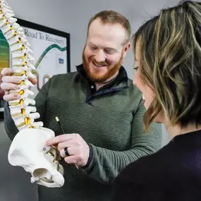 Dr. Lance Zuidema educating patient on the spine.
