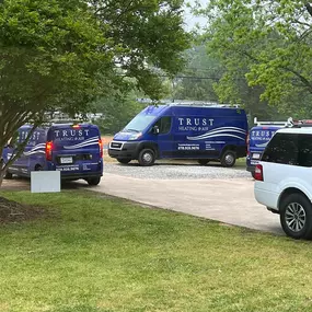 A fleet of branded Trust Heating and Air service vans is parked and ready for dispatch, showcasing the company’s professional presence and commitment to fast, reliable HVAC and refrigeration service across Northeast Georgia. Each van features the Trust Heating and Air logo and contact information, reinforcing brand visibility and mobile response capability for residential and commercial heating, cooling, and walk-in refrigeration needs.