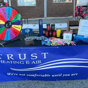 Trust Heating and Air showcases their brand at a local vendor event in Northeast Georgia, engaging with community members and sharing information about their residential and commercial HVAC and refrigeration services. The booth features banners, promotional materials, and friendly team members answering questions about air conditioning repair, heating system maintenance, and walk-in cooler and freezer services. A great image to highlight Trust Heating and Air’s commitment to local outreach, cust