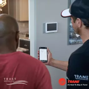 An HVAC technician stands beside a smiling customer, discussing the completed service or explaining next steps for their heating and cooling system. The technician is in uniform, holding tools or paperwork, while the customer looks reassured and satisfied. This image highlights trust, professionalism, and quality customer service—key values in residential and commercial HVAC repair, maintenance, and installation. Ideal for promoting friendly, expert service and building confidence with potential
