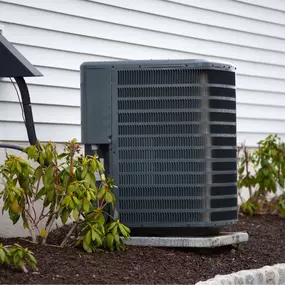 A residential HVAC unit is installed outside a home, positioned on a concrete pad next to the exterior wall. The system is clean and professionally installed, representing reliable heating and cooling performance for year-round indoor comfort. This image highlights the importance of proper A/C and furnace installation, energy-efficient HVAC systems, and regular maintenance to keep homes in Northeast Georgia comfortable in every season.