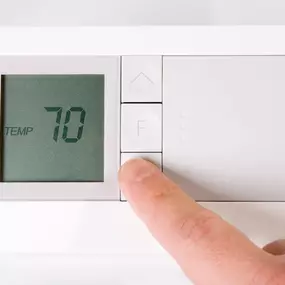 A close-up view of a digital thermostat set to 70 degrees, displaying a clear and modern interface. The temperature setting represents an ideal comfort level for many households, symbolizing efficient heating or cooling operation. This image highlights home energy efficiency, indoor climate control, and the importance of a properly functioning HVAC system for year-round comfort. Perfect for promoting HVAC tune-ups, smart thermostat installations, or energy-saving tips.